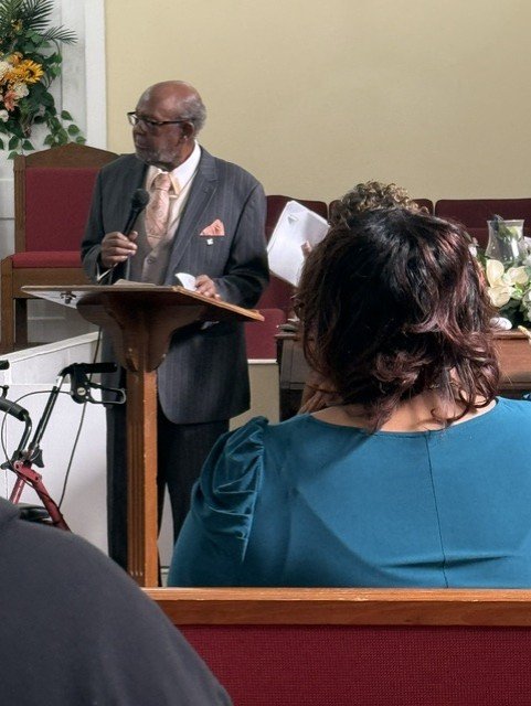 Pastor Rev. E. C. Huntley at the pulpit